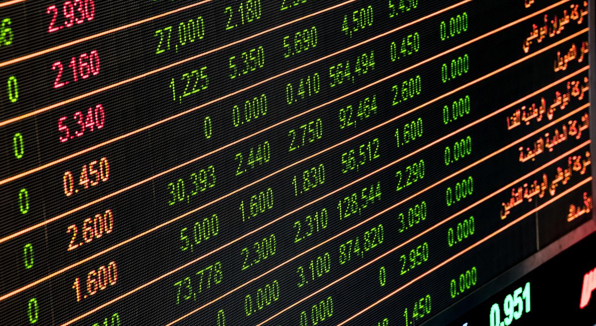 Singapore stock market trading floor with financial charts showing dividend stock performance
