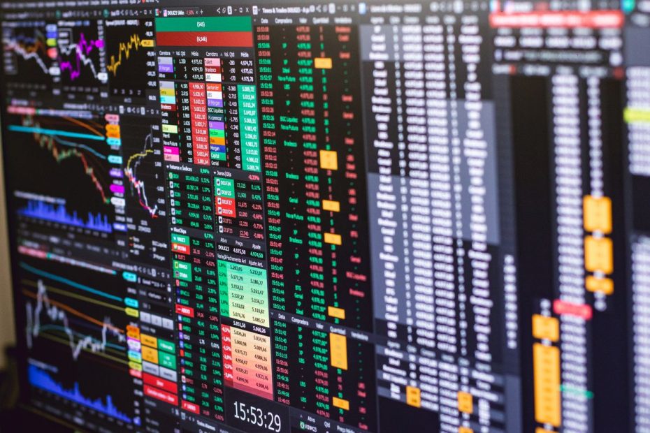Financial trading screen with colorful stock market charts for Singapore unit trust vs ETF comparison