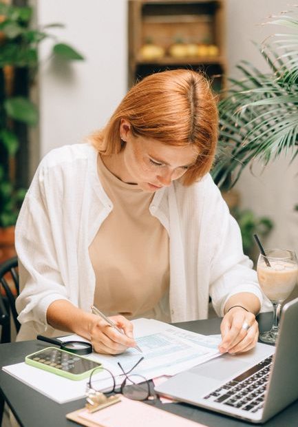 Singapore freelancer tax guide - person working on laptop with tax documents