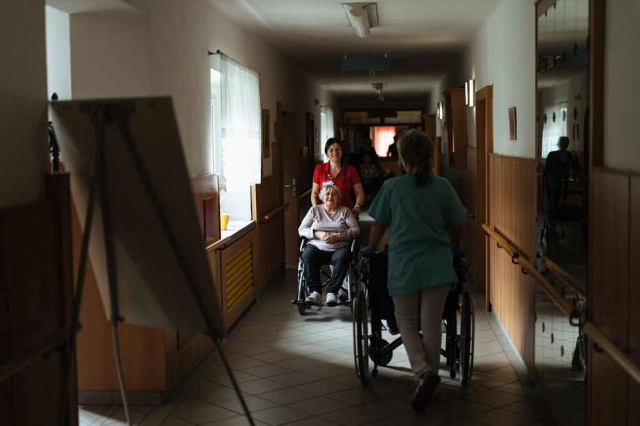 ElderShield vs CareShield Life Singapore - caregiver assisting elderly woman in wheelchair