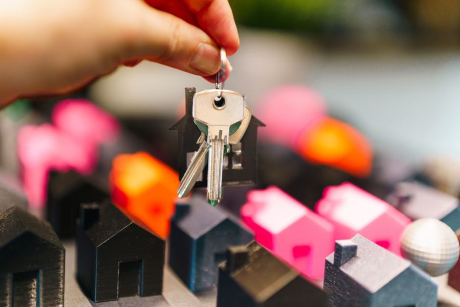 Seller stamp duty Singapore 2026: hand holding house keys with miniature houses