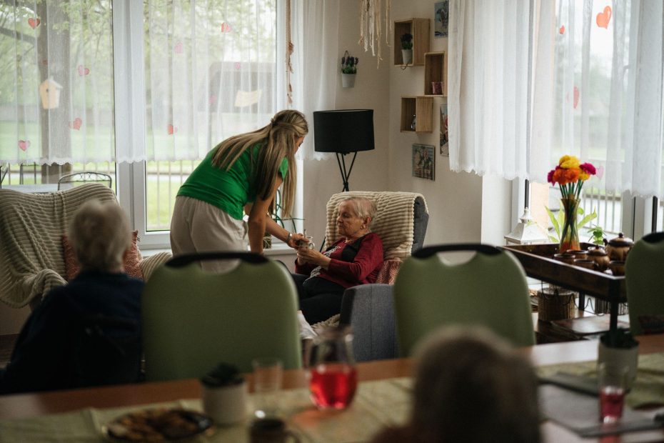 Singapore nursing home cost 2026 - caregiver assisting elderly residents in a nursing home