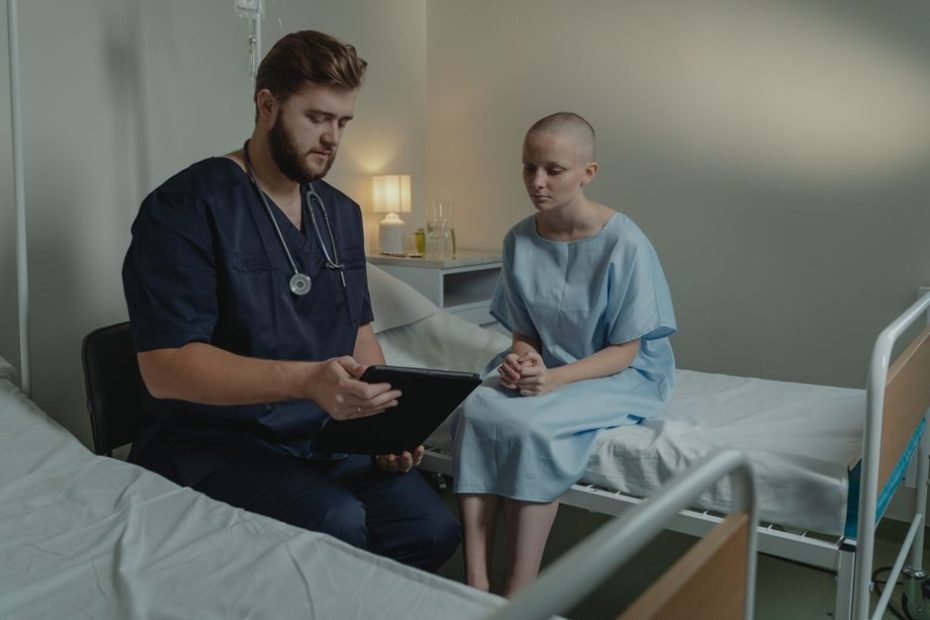 MediFund Singapore - doctor in a hospital ward consulting a patient