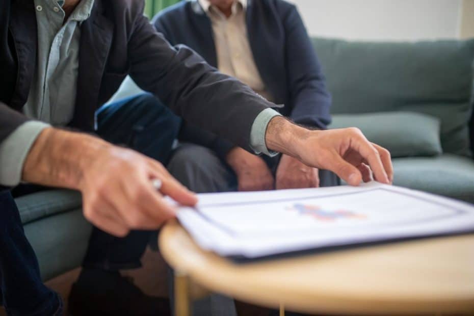 Singapore insurance broker comparing policy options with a client, 2026