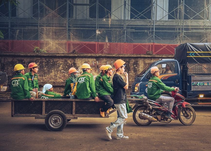 Singapore work permit and S Pass 2026 - foreign workers at a construction site in Singapore